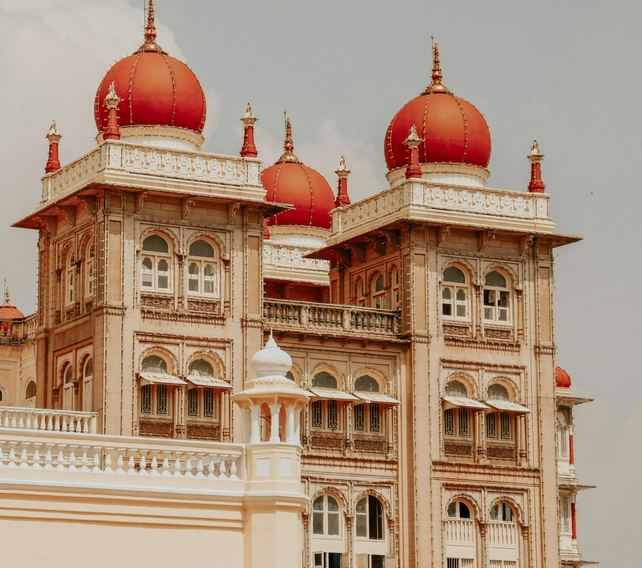 a yellow and white building with two orange domes on top