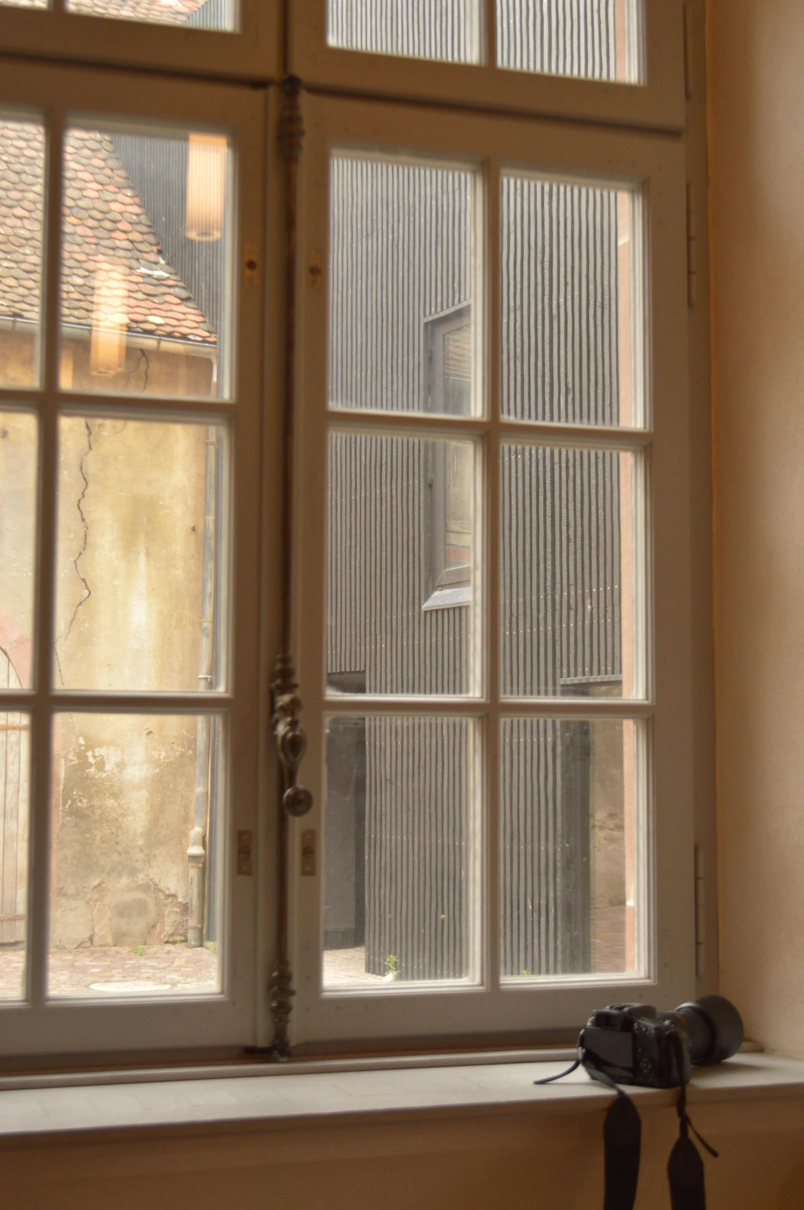 an open window shows a view of a building