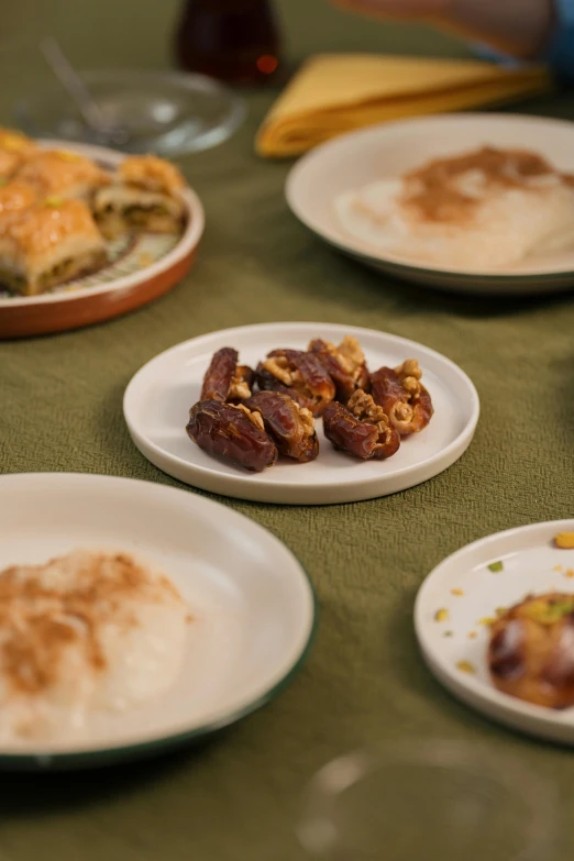 seven plates sitting on the table with various foods