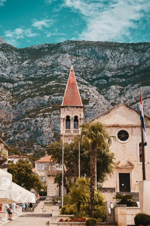 there is a small church in front of mountains