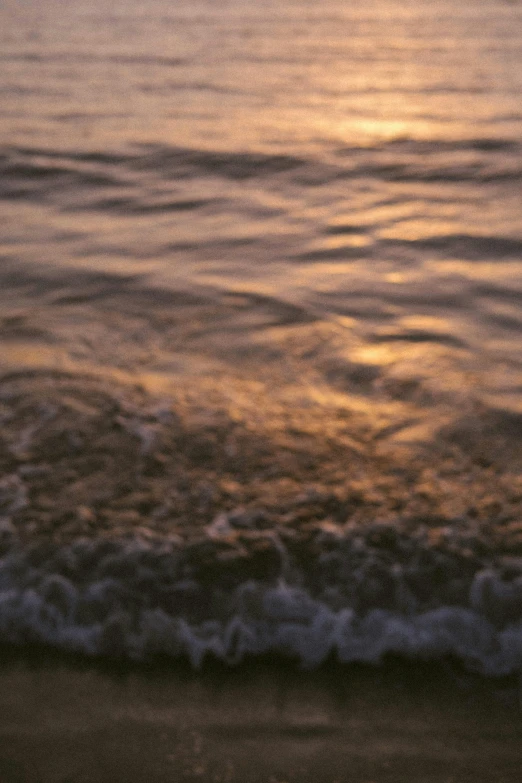 an orange, yellow and green ocean sunset over water