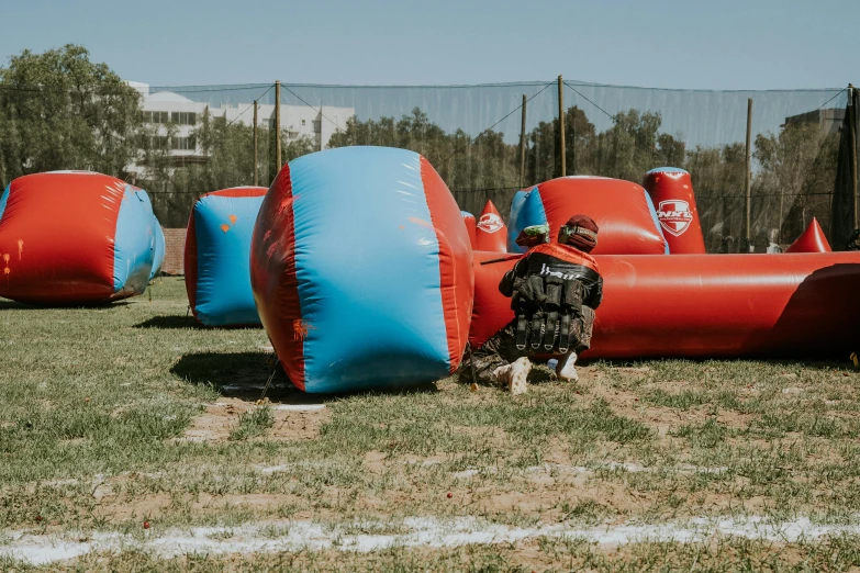 a boy is standing next to some inflatable structures