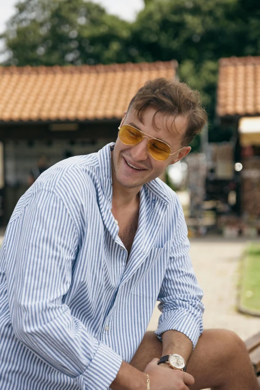 a man wearing sunglasses and looking off into the distance