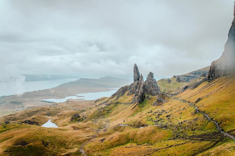 two mountain sides on a foggy day