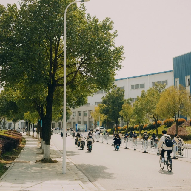 the city has people on bicycles, walking and riding