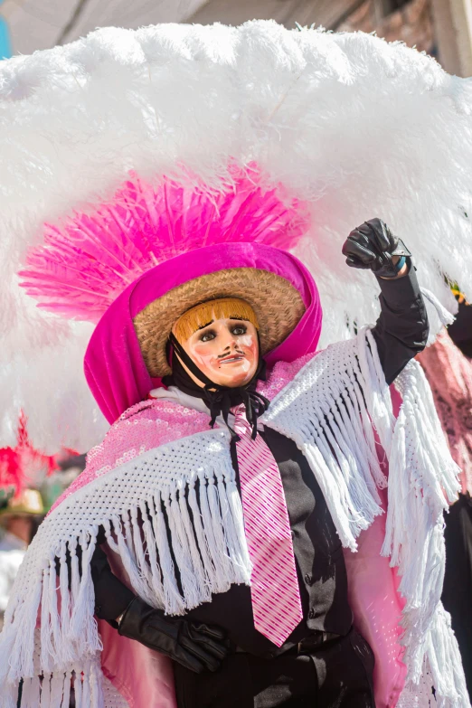 the woman in pink has a white feathered hat