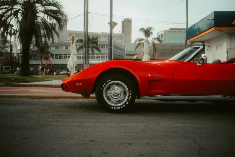 red sports car sitting on the street with its door open