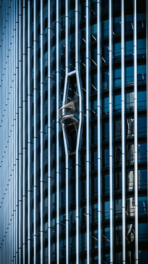 a tall, black building with various angles and a window