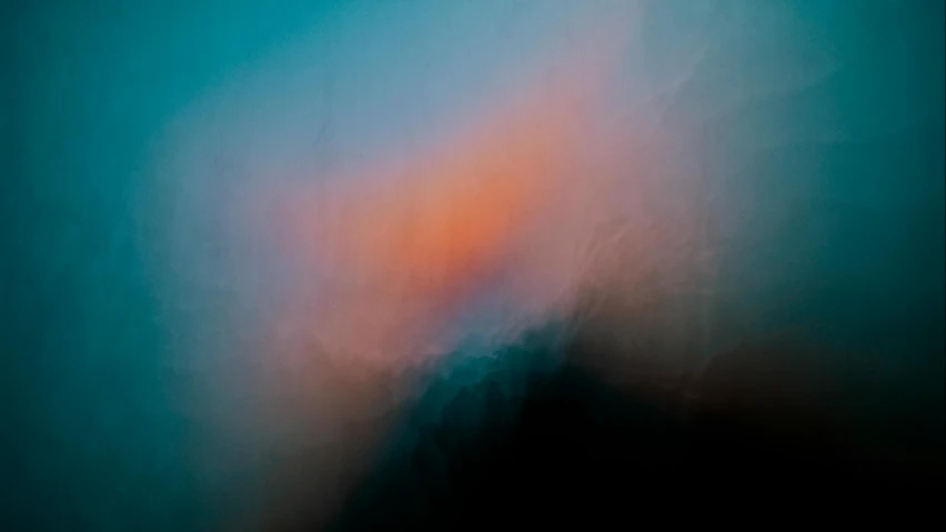 a large blurry image with a blue and orange color