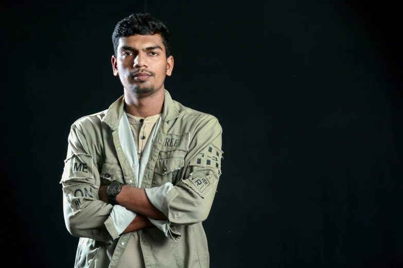 a man posing for a portrait on a black background