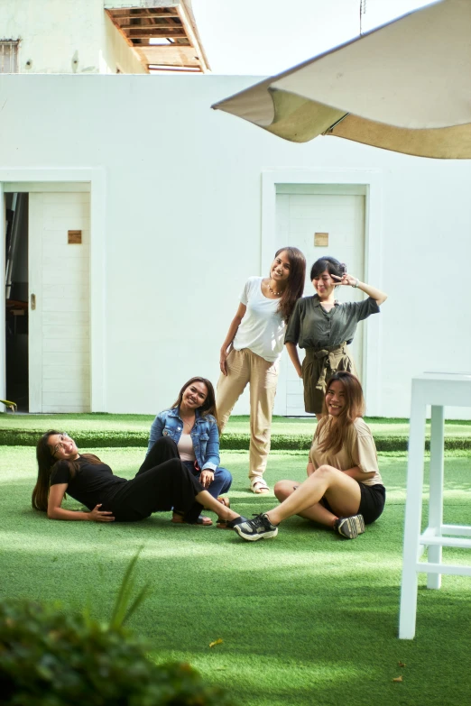 a group of people that are standing in the grass