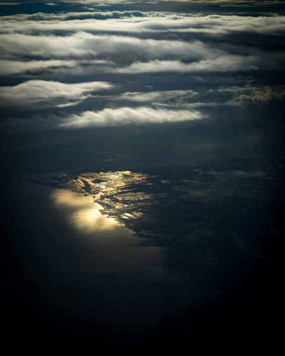 a sunset seen from above the clouds over land