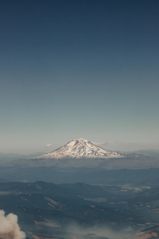 a mountain covered in snow is pictured from a small plane