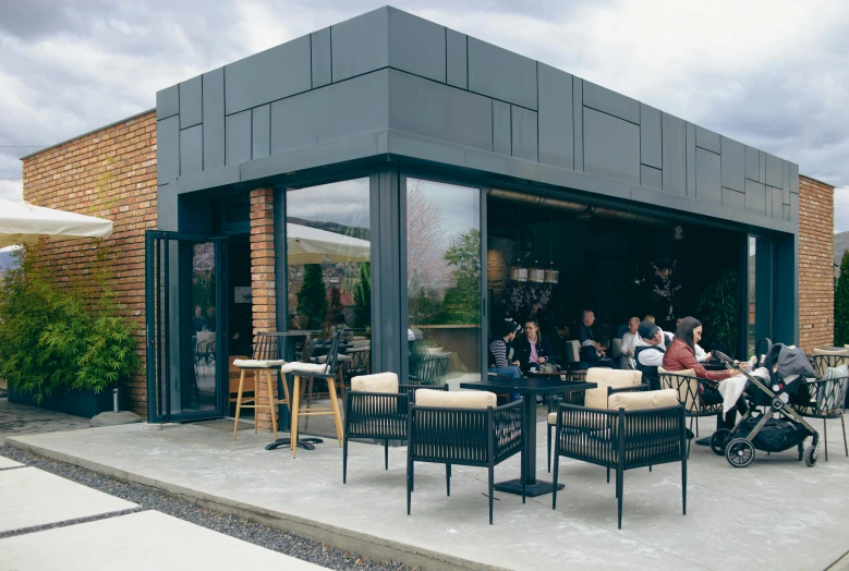 an outdoor restaurant has a large glass windows