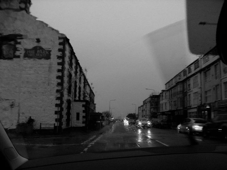 black and white pograph of cars driving on street