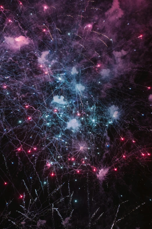 a fireworks filled sky at night during the holidays