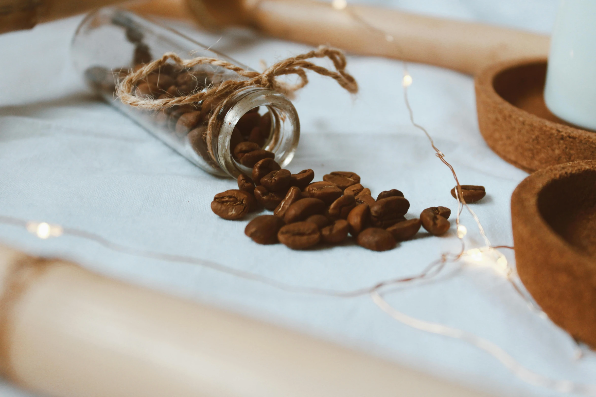 some coffee beans and a jar on a table