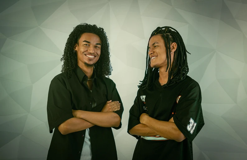 two people posing in front of a white background