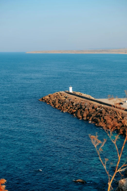 a body of water with a long pier in the middle