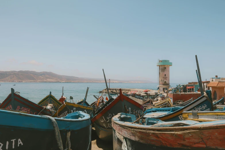 many different types of boats sitting on the sand