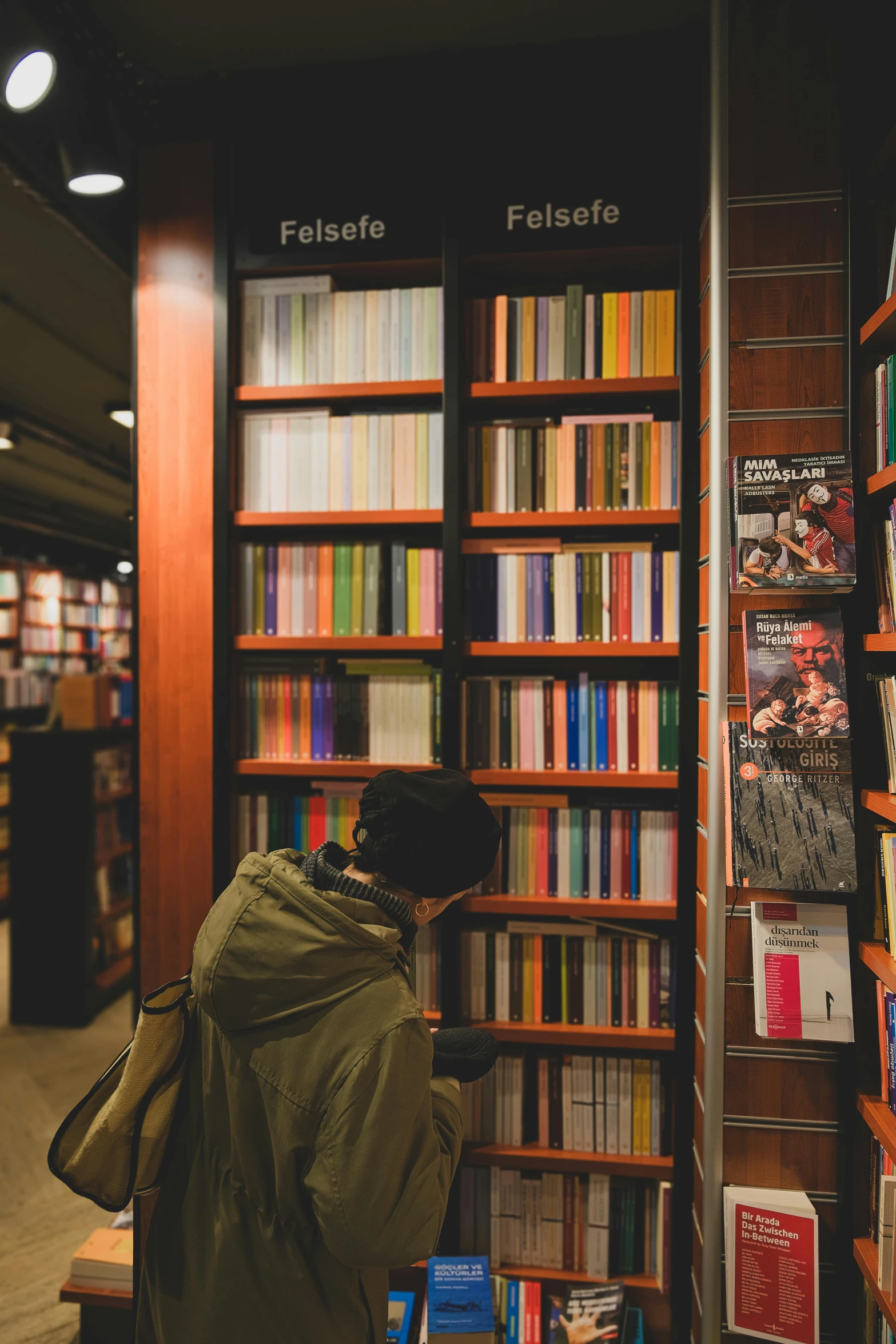 a person is in front of a wall of books