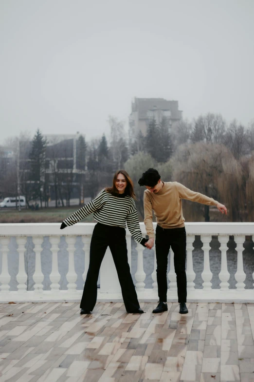 a couple of people standing on top of a brick walkway