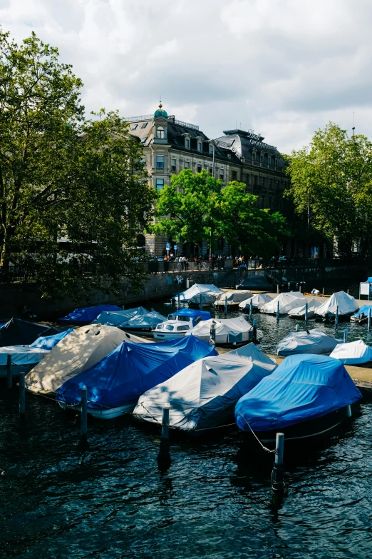 a bunch of small boats parked in the water