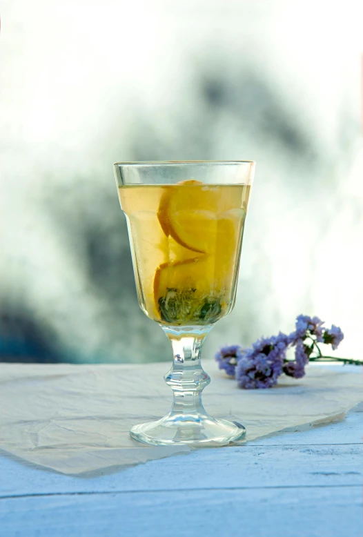 a lemonade cocktail sitting on top of a wooden table