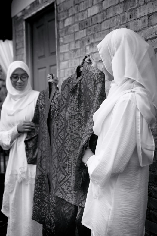 black and white pograph of three women wearing traditional muslim garb