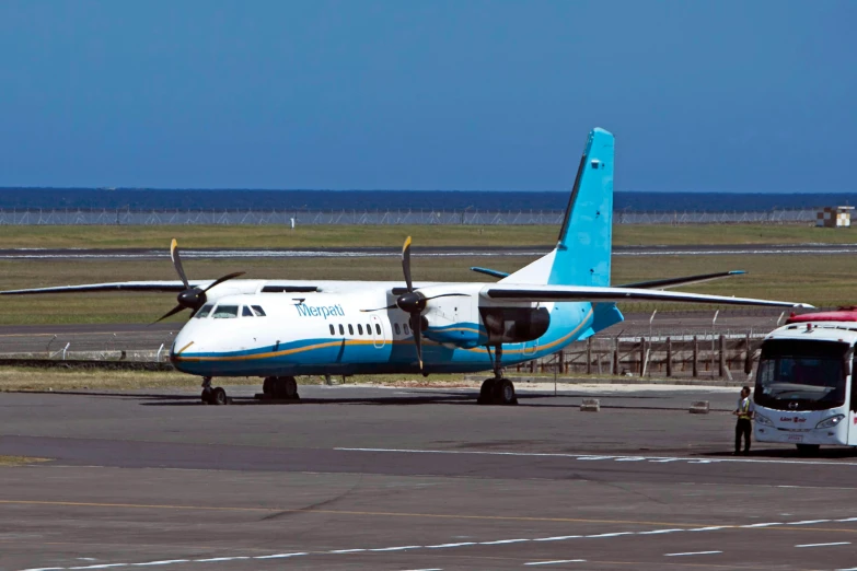 an airplane is parked on the tarmac next to a vehicle