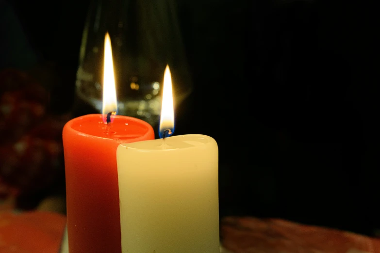 two candles sitting on top of a table