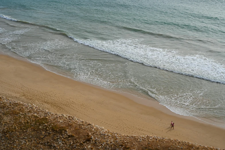 a view of the ocean with one person walking in the water