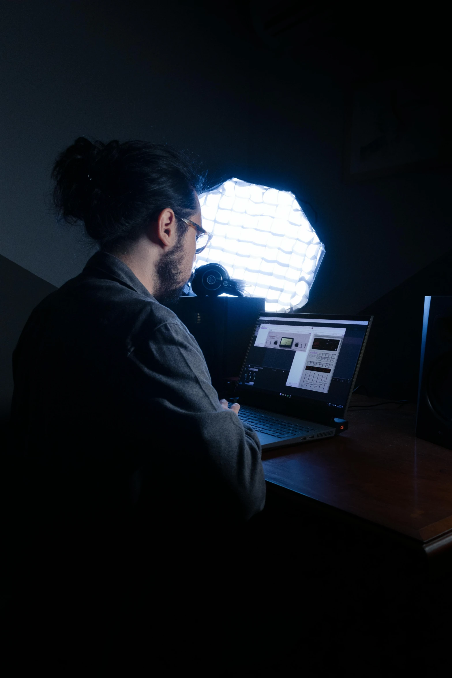 a person sitting at a desk in front of a computer