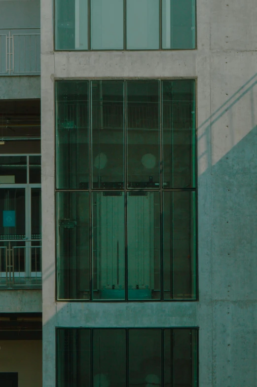 a building with several windows and balconies near the street