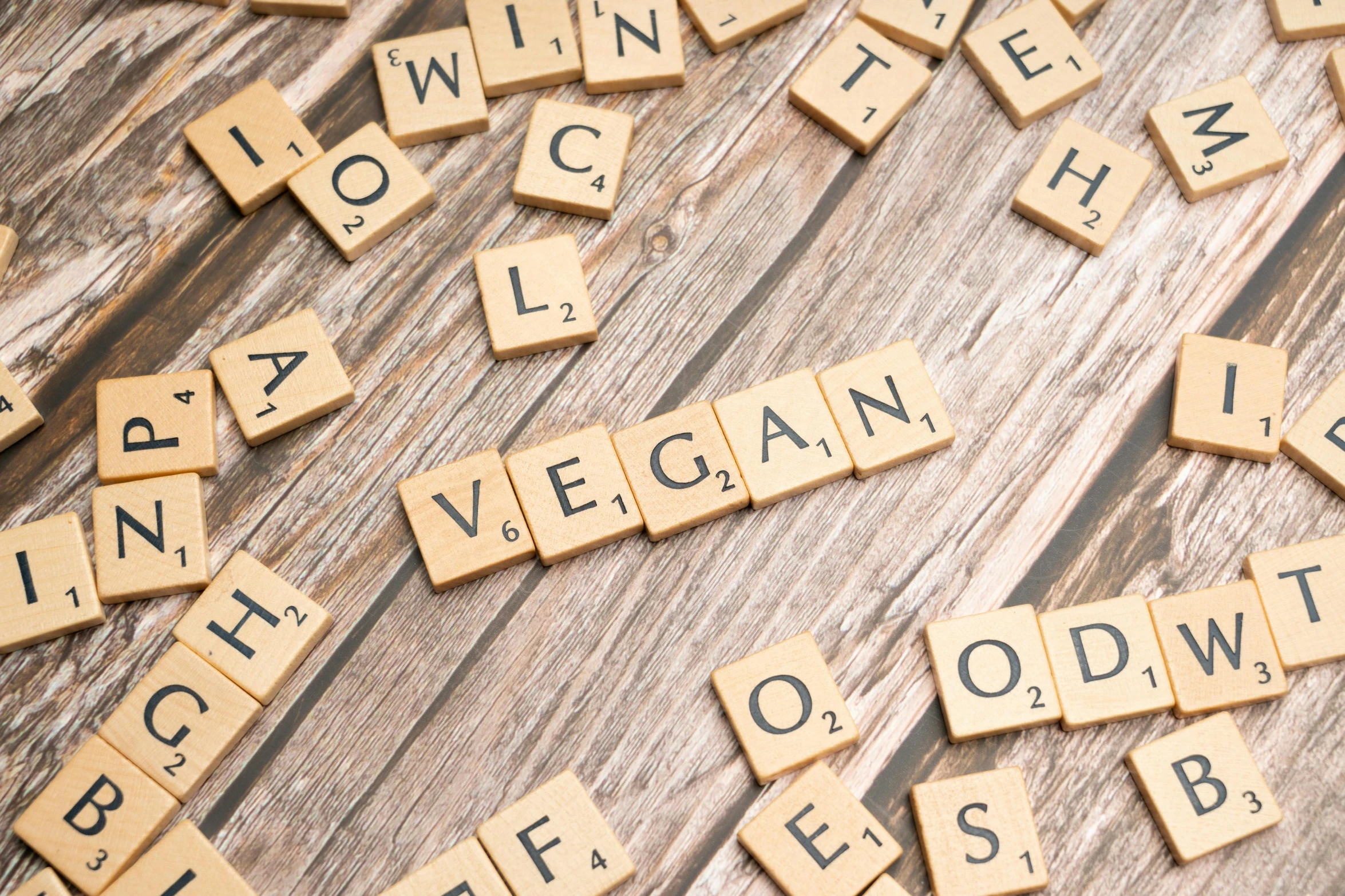 scrabble tiles spelling out the words healthy, low carb and low carbs on a table