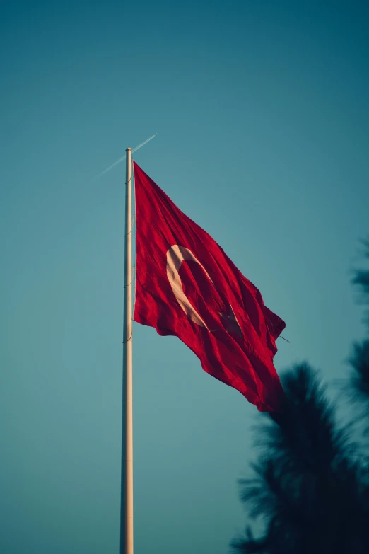 a big flag on top of a tower