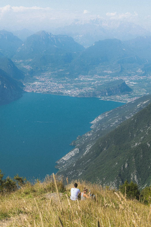 a man is sitting on top of a hill