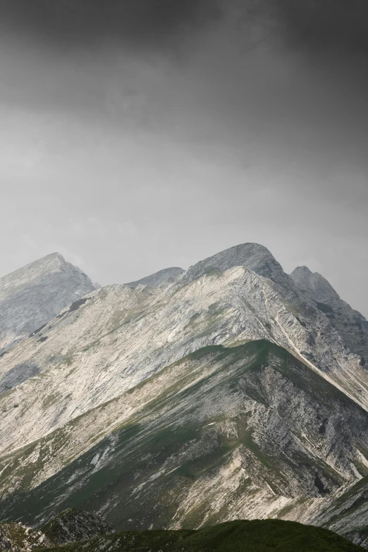 some mountain sides with trees and bushes on the ground