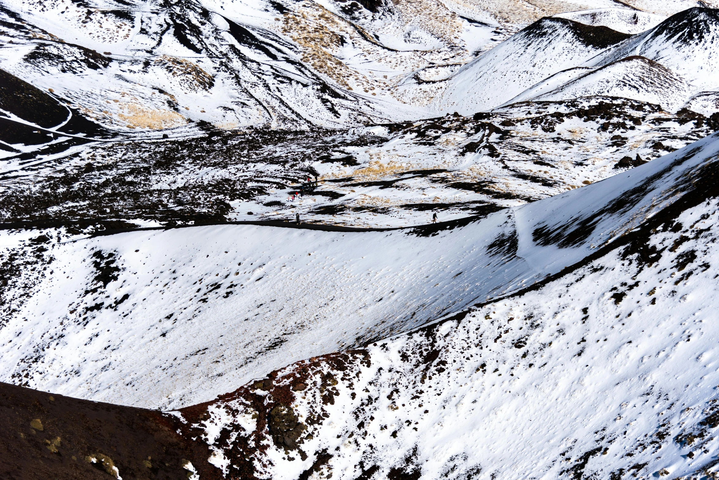 the mountains are covered in snow as a skier is seen above