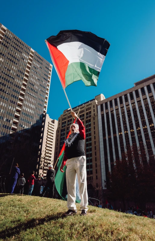 a man waves an american and italian flag while holding his hands out