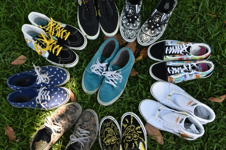 several pairs of shoes are shown on the grass