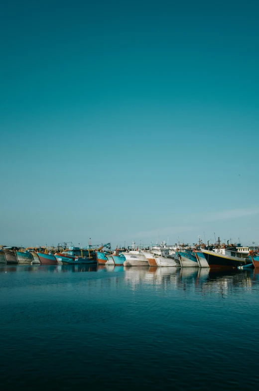 there are many boats floating along the water