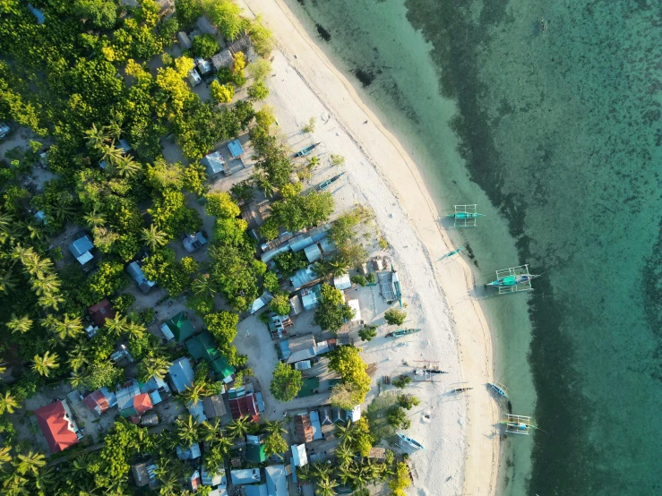 a sea and a beach with some canoes on the shore