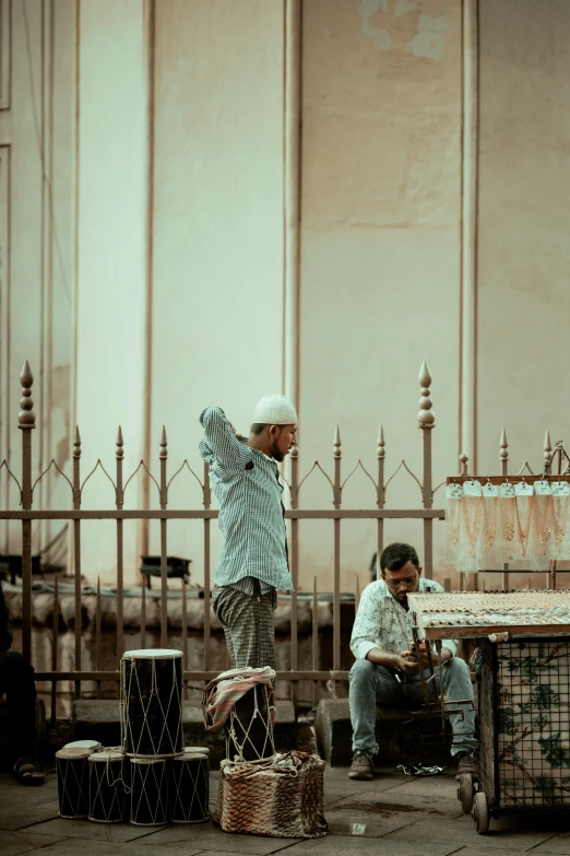 two people sitting on some chairs in the street