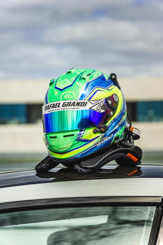 a helmet resting on top of the roof of a car