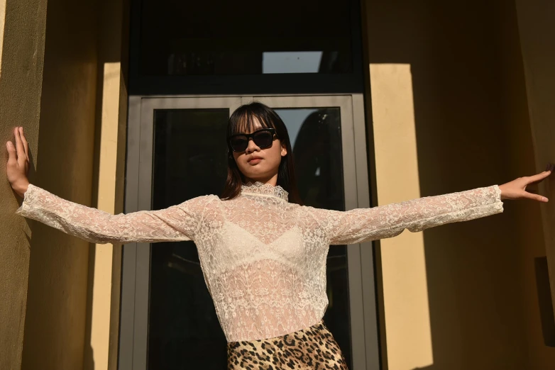 a woman wearing sunglasses is standing outside