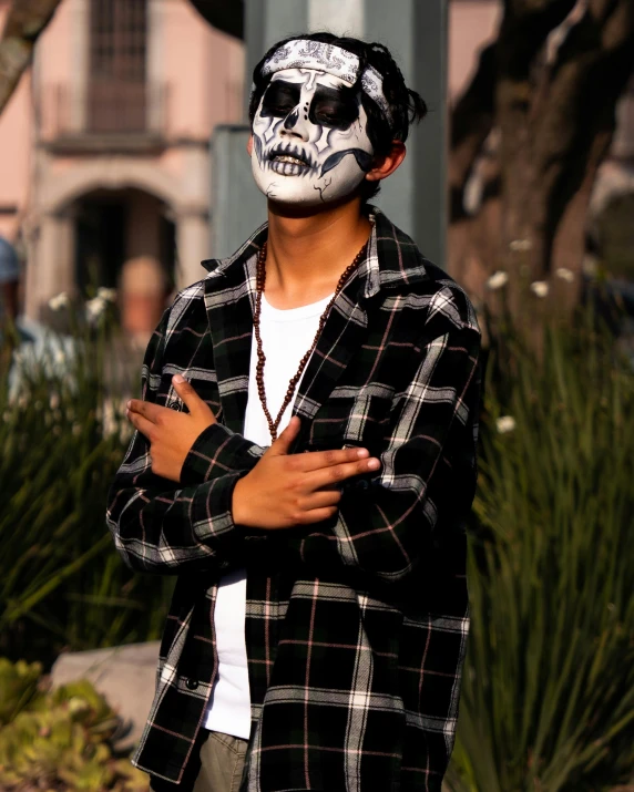 man with skull face paint in a residential area