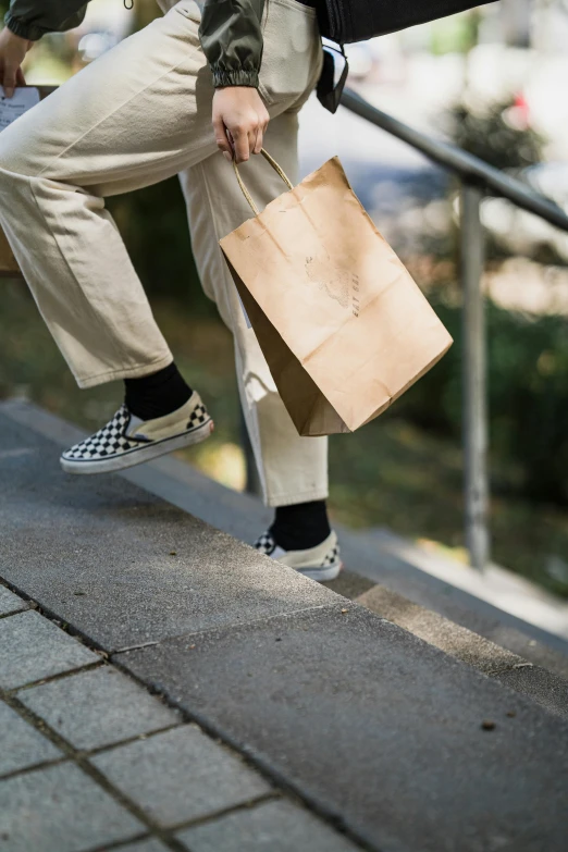 a man carrying a shopping bag and a brown paper bag