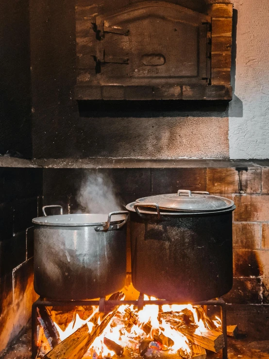 pot over fire in indoor oven on top of stone