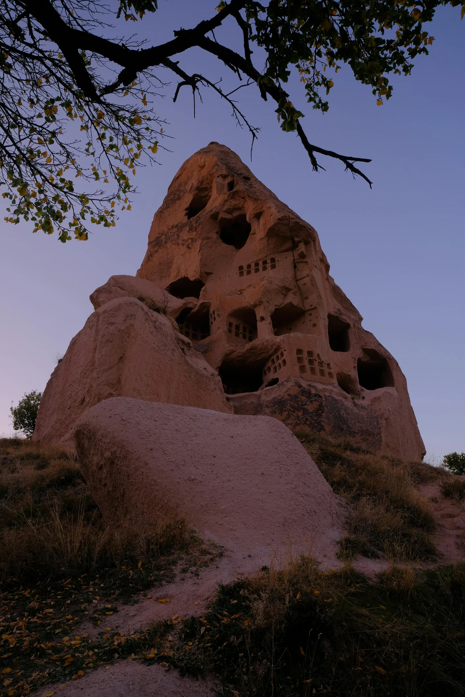 a large boulder with little holes in the top